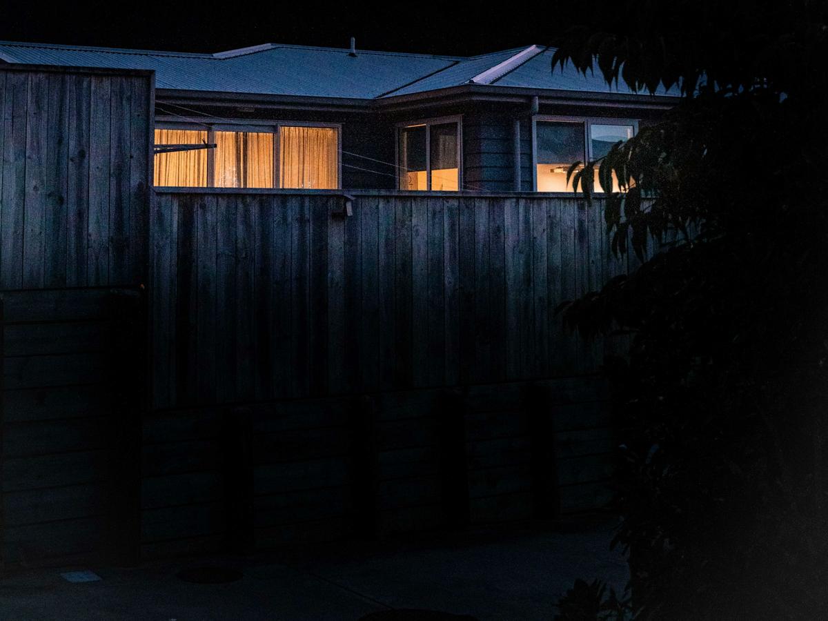 Home with warm lights on at dusk